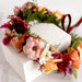 Floral crown with ranunculus, roses, dahlias, and other flowers